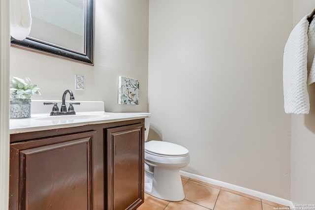 bathroom featuring tile patterned flooring, vanity, and toilet