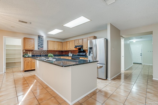 kitchen featuring a kitchen island, light tile patterned flooring, stainless steel refrigerator with ice dispenser, and black electric range