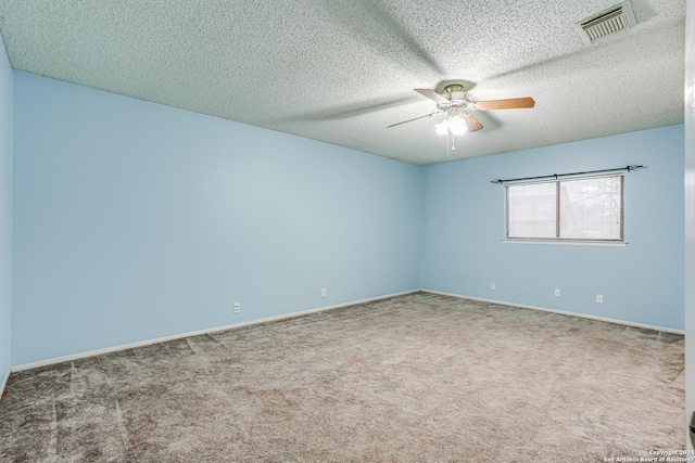 carpeted spare room with ceiling fan and a textured ceiling