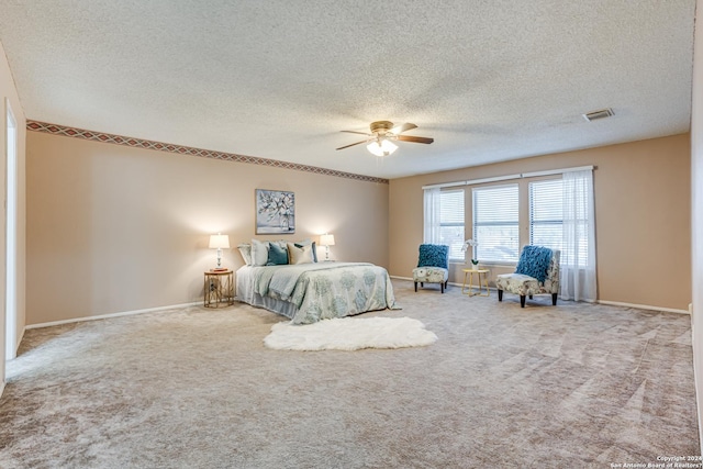 bedroom with carpet flooring, ceiling fan, and a textured ceiling