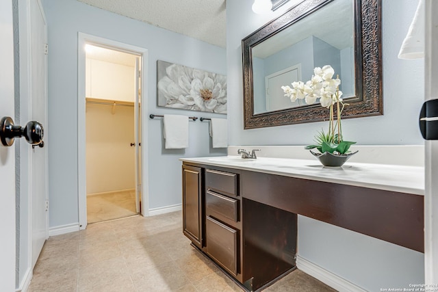 bathroom with vanity and a textured ceiling