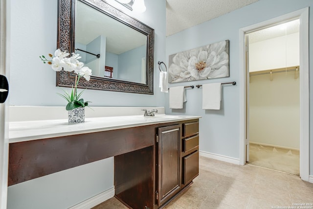 bathroom with a textured ceiling and vanity