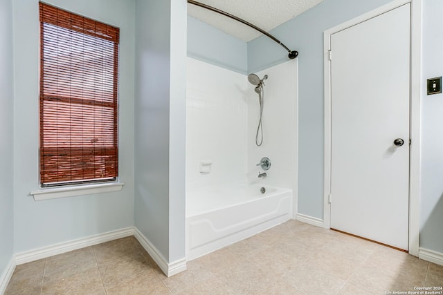 bathroom featuring shower / bathing tub combination and a textured ceiling