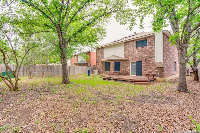 rear view of house with a wooden deck