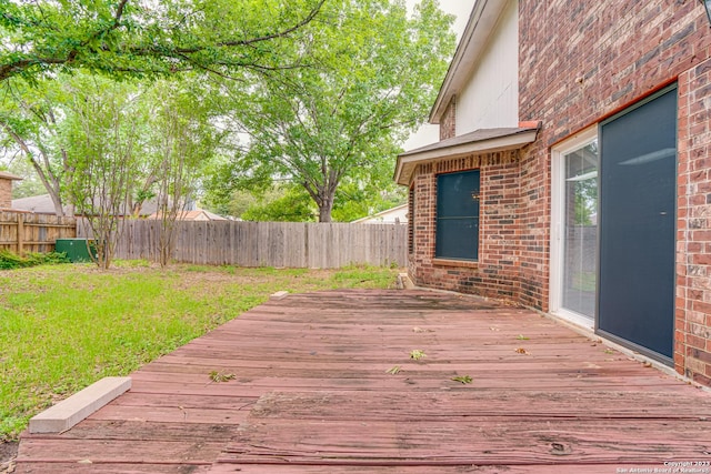 wooden deck with a lawn