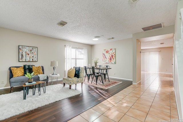 tiled living room with a textured ceiling