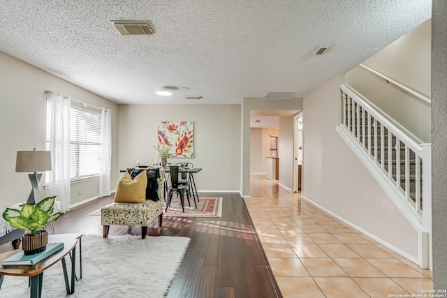 interior space featuring a textured ceiling and light hardwood / wood-style flooring