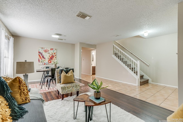 living room featuring hardwood / wood-style flooring and a textured ceiling