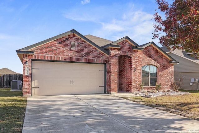 view of front of home featuring a garage and central AC unit