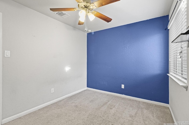 carpeted empty room featuring ceiling fan