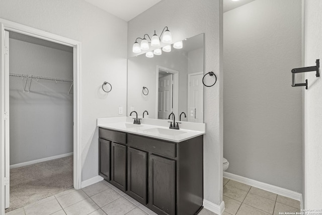 bathroom with tile patterned floors, vanity, and toilet