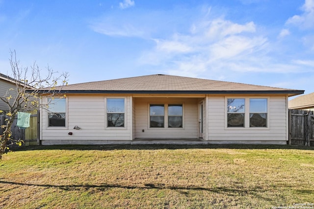 rear view of house with a lawn