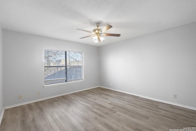 spare room featuring hardwood / wood-style flooring, ceiling fan, and a textured ceiling