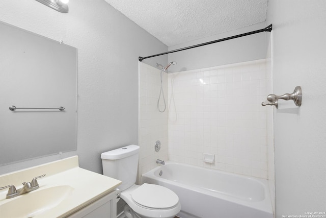 full bathroom with vanity,  shower combination, toilet, and a textured ceiling