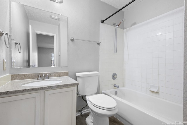 full bathroom with vanity,  shower combination, toilet, and a textured ceiling