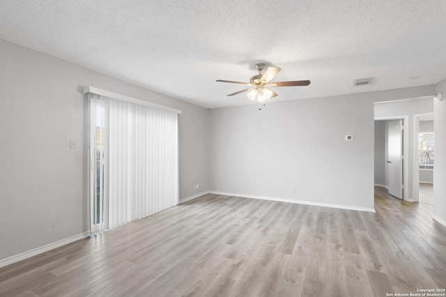 unfurnished room with ceiling fan, a textured ceiling, and light hardwood / wood-style flooring