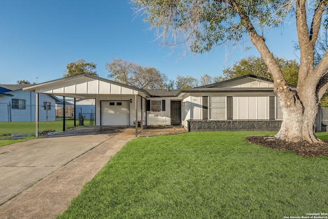 ranch-style house featuring a front lawn, a garage, and a carport