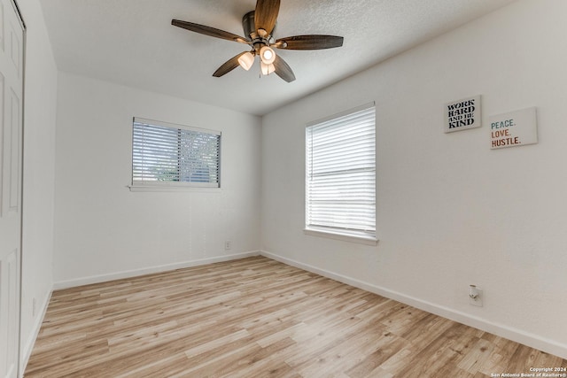 unfurnished room featuring ceiling fan and light wood-type flooring