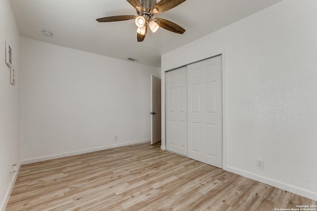 unfurnished bedroom with a closet, light hardwood / wood-style floors, and ceiling fan