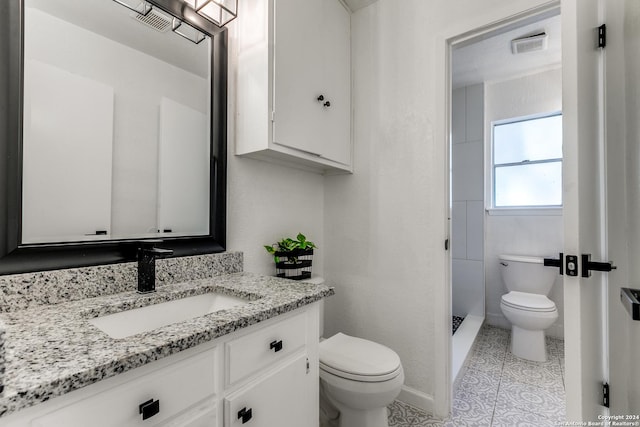 bathroom featuring tile patterned floors, vanity, toilet, and walk in shower