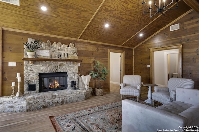 living room featuring a fireplace, wood-type flooring, lofted ceiling, and wood walls