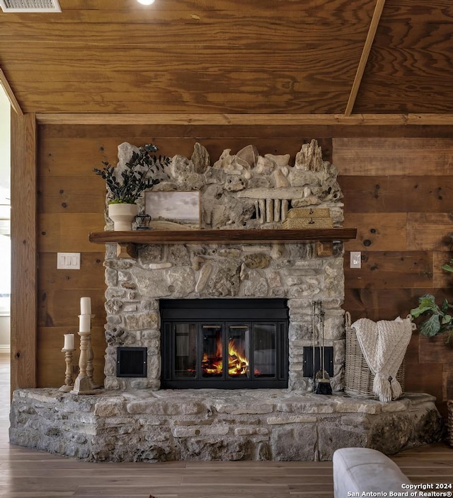 details featuring wood walls, a fireplace, wood ceiling, and wood-type flooring