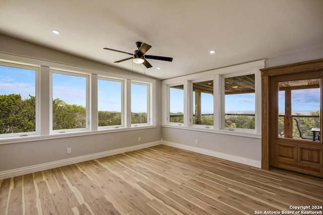 unfurnished sunroom featuring ceiling fan and vaulted ceiling