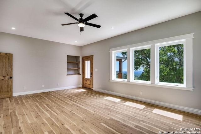 interior space with ceiling fan and light hardwood / wood-style flooring