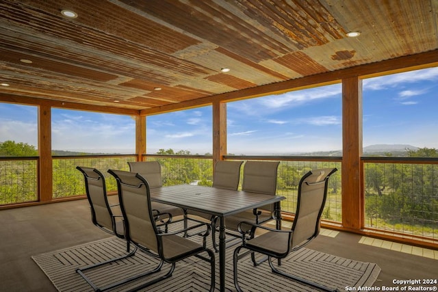 sunroom / solarium with plenty of natural light and wooden ceiling