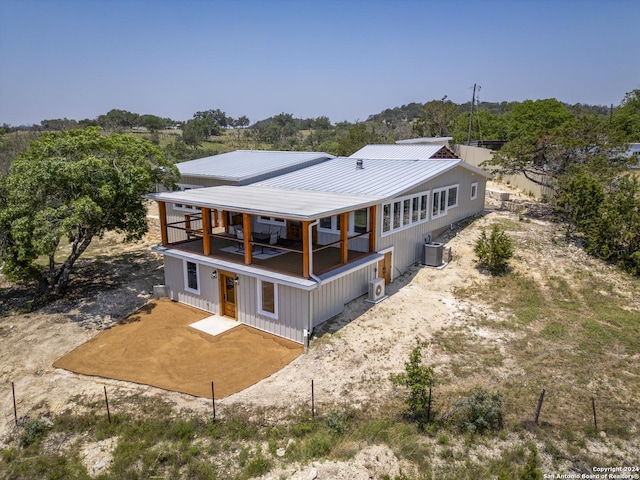 back of house with central AC unit and a balcony