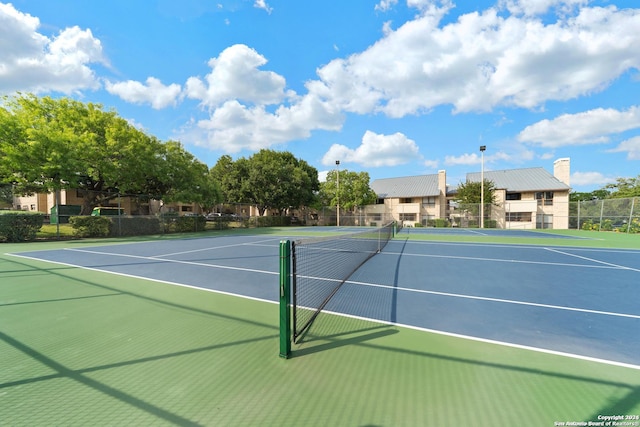 view of tennis court featuring basketball court