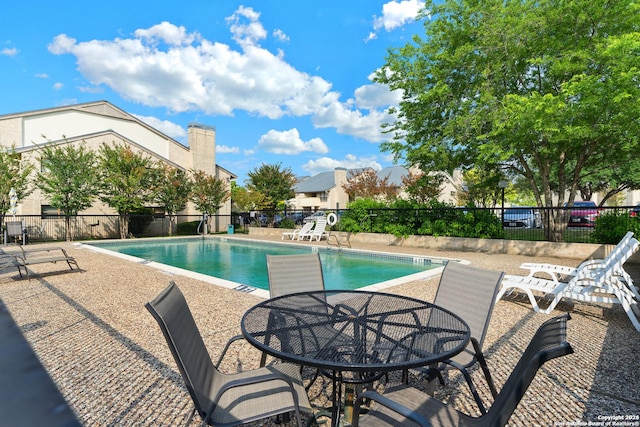 view of swimming pool with a patio area