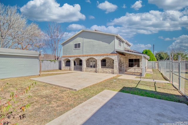 rear view of property with a yard and a patio area