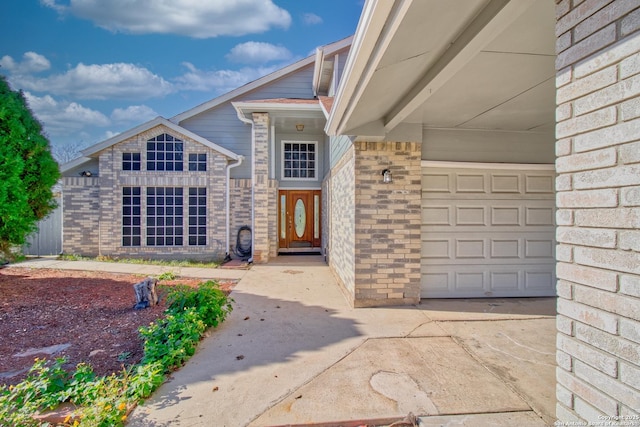 doorway to property with a garage