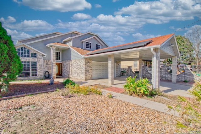 craftsman-style house with solar panels and a garage