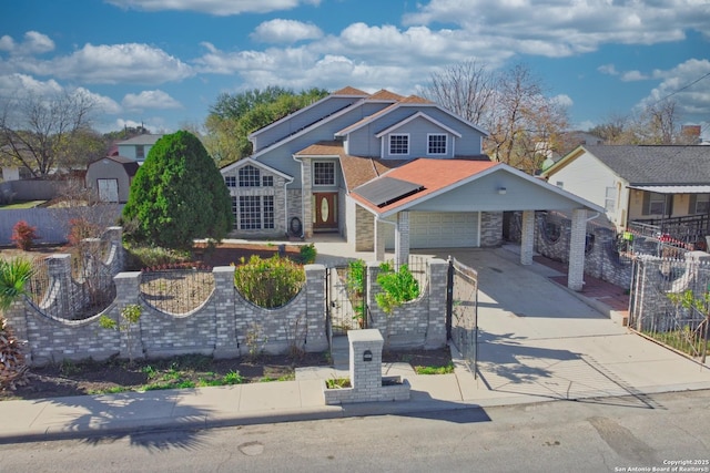 view of front of property featuring solar panels and a garage