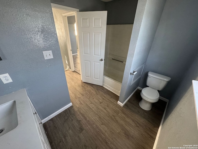 bathroom with hardwood / wood-style floors, vanity, and toilet