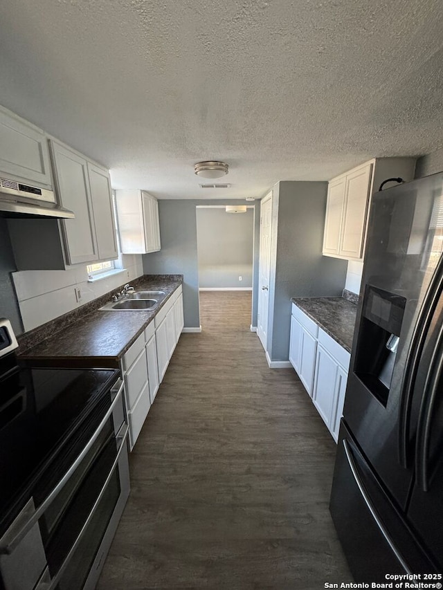 kitchen with white cabinets, sink, a textured ceiling, range hood, and stainless steel appliances