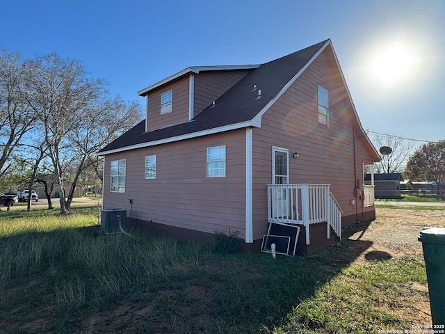 view of home's exterior featuring a yard and cooling unit