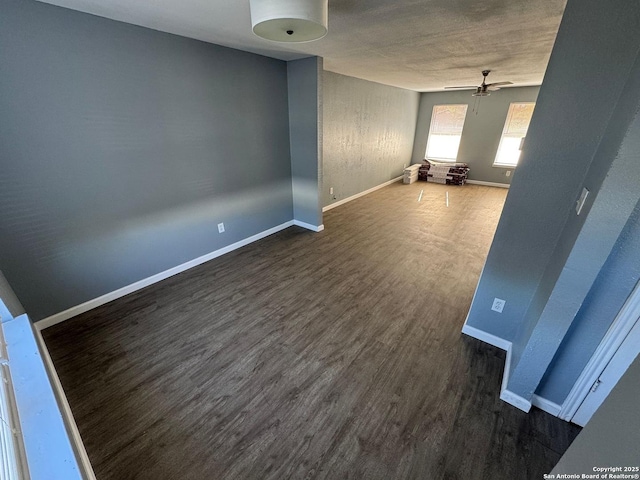 unfurnished room featuring ceiling fan and dark wood-type flooring