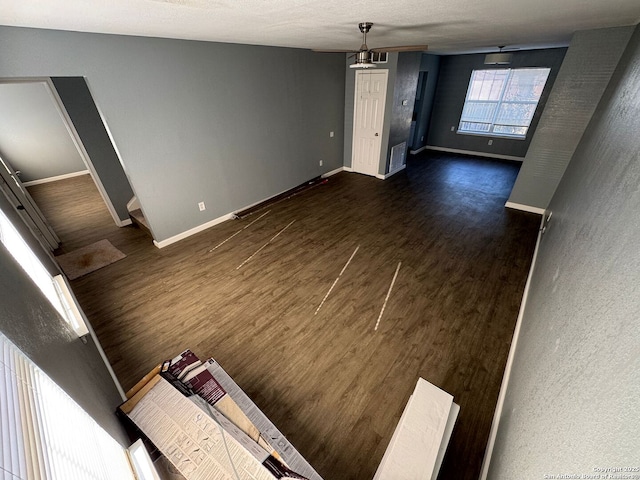 unfurnished living room with dark hardwood / wood-style flooring