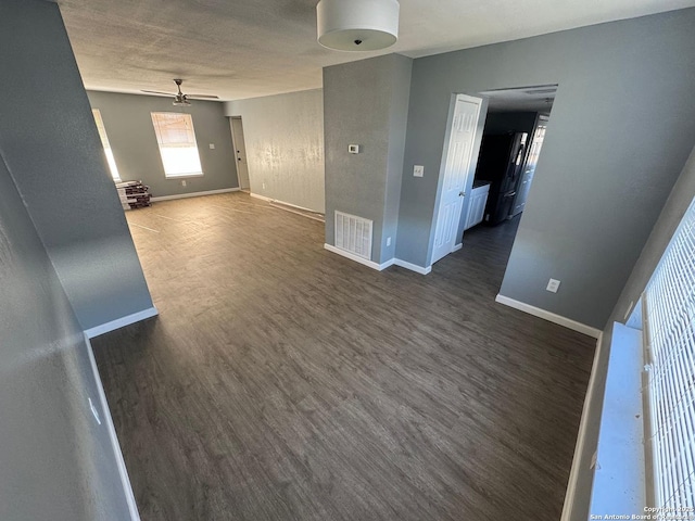 empty room featuring ceiling fan and dark hardwood / wood-style flooring