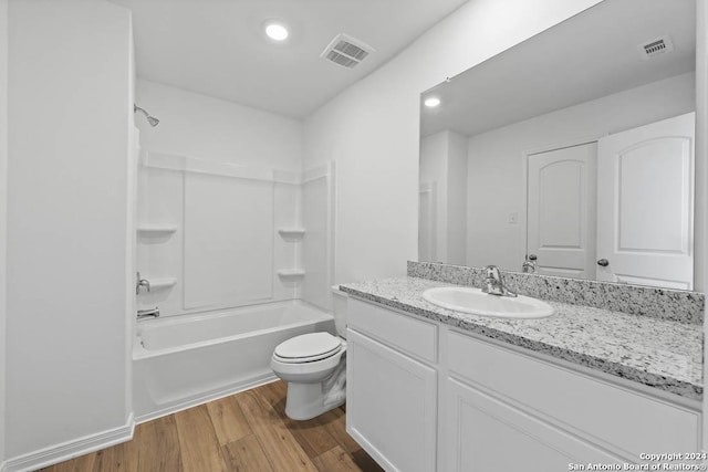 full bathroom with toilet, wood-type flooring, vanity, and bathing tub / shower combination