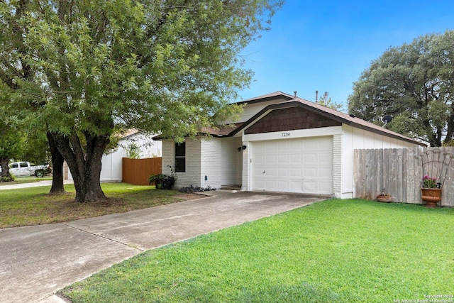 view of front of home featuring a front lawn and a garage