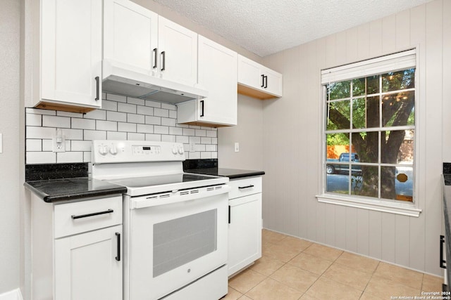 kitchen featuring white range with electric stovetop, white cabinetry, a textured ceiling, and light tile patterned floors