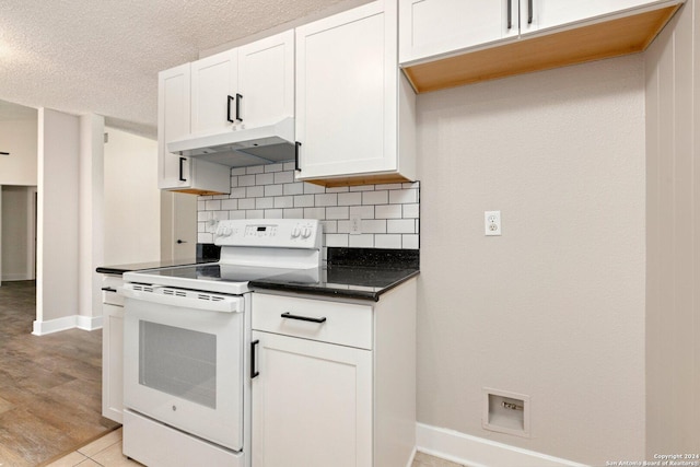 kitchen with backsplash, a textured ceiling, white range with electric cooktop, white cabinetry, and light tile patterned flooring