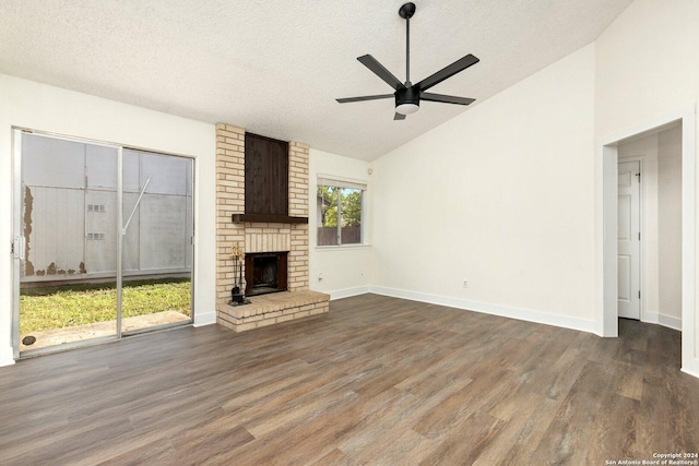 unfurnished living room with lofted ceiling, ceiling fan, dark wood-type flooring, and a textured ceiling