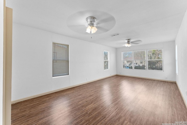 spare room featuring dark hardwood / wood-style floors and ceiling fan