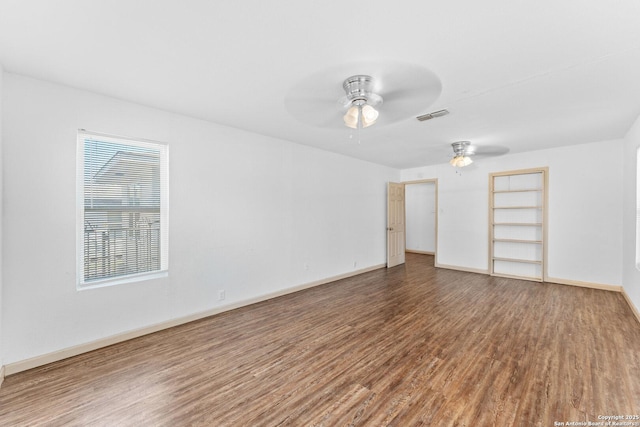 empty room with hardwood / wood-style flooring and ceiling fan