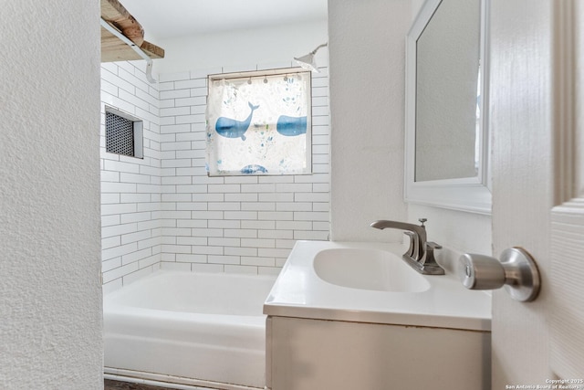 bathroom with vanity and tiled shower / bath combo